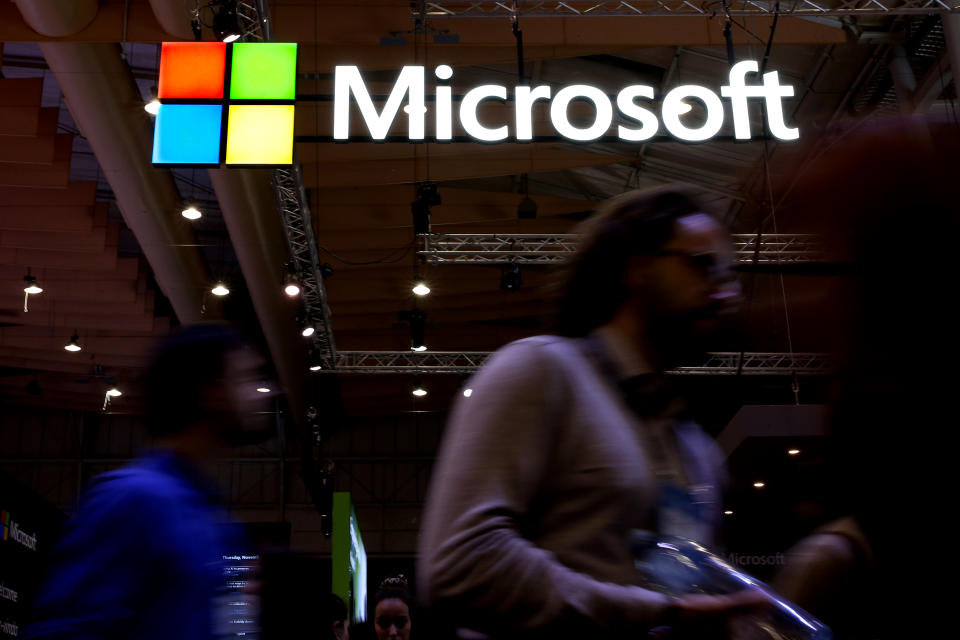 People pass by the Microsoft logo during the annual Web Summit technology conference in Lisbon, Portugal on November 6, 2019. (Photo by Pedro Fiúza/NurPhoto via Getty Images)