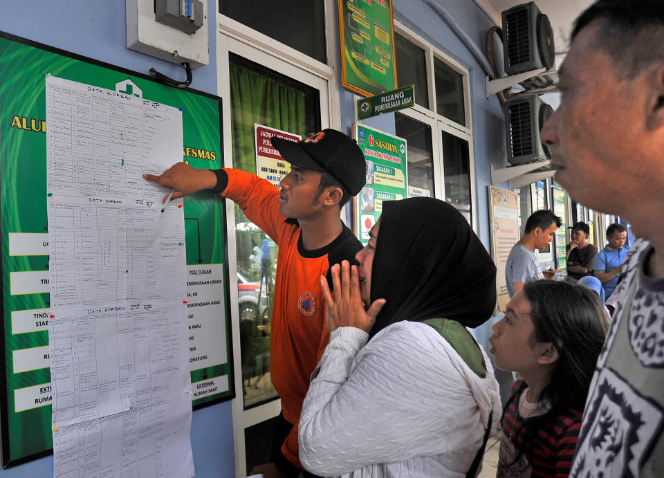 A women cries as she reads a list of victims who were killed in a tsunami, at Carita in Padeglang, Banten province, Indonesia, Dec. 23, 2018. (Photo: Antara Foto/Asep Fathulrahman via Reuters)