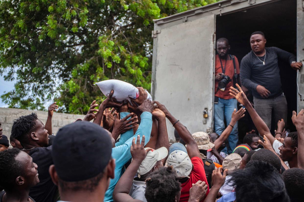 Haitians quarrel over a bag of food as part of the humanitarian aid provided by FAES (Fund for Economic and Social Assistance) after a 7.2-magnitude earthquake struck Haiti on August 16, 2021 in Les Cayes, Haiti.  (Getty Images)