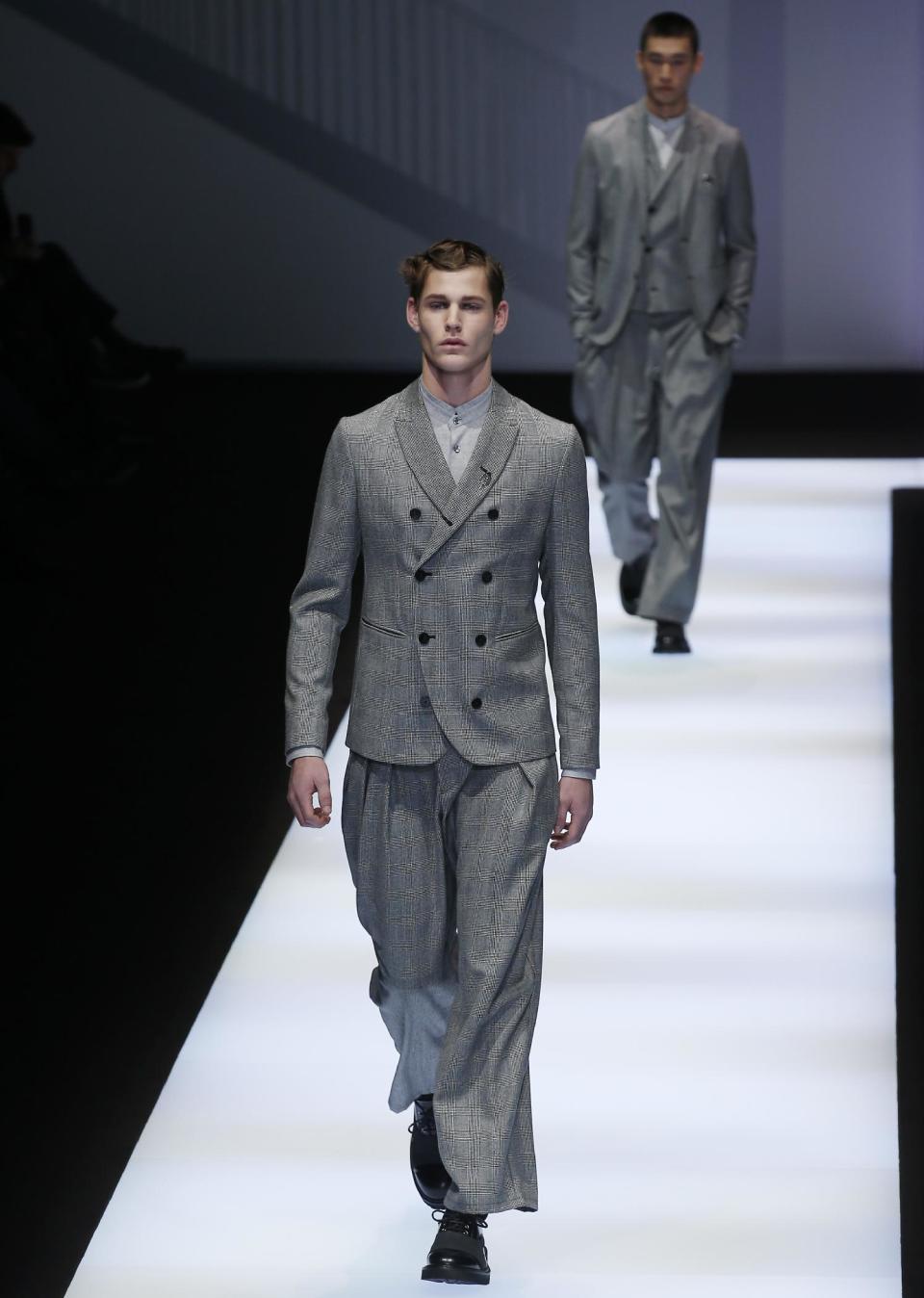 Models wear creations for Emporio Armani men's Fall-Winter 2017-2018 collection, part of the Milan Fashion Week, unveiled in Milan, Italy, Saturday, Jan. 14, 2017. (AP Photo/Antonio Calanni)