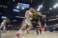 Golden State Warriors guard Stephen Curry (30) drives to the basket against Detroit Pistons forward Bojan Bogdanovic during the first half of an NBA basketball game in San Francisco, Friday, Jan. 5, 2024. (AP Photo/Jeff Chiu)