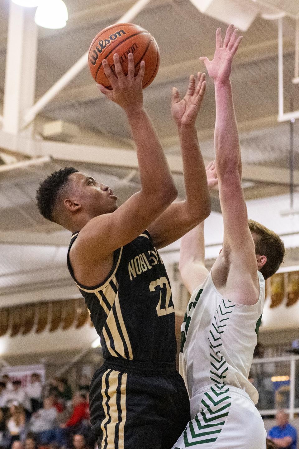 Noblesville High School sophomore Aiden Brewer (22) shoots during the first half of an IHSAA Sectional basketball game against Westfield High School, Friday, March 3, 2023, at Carmel High School.