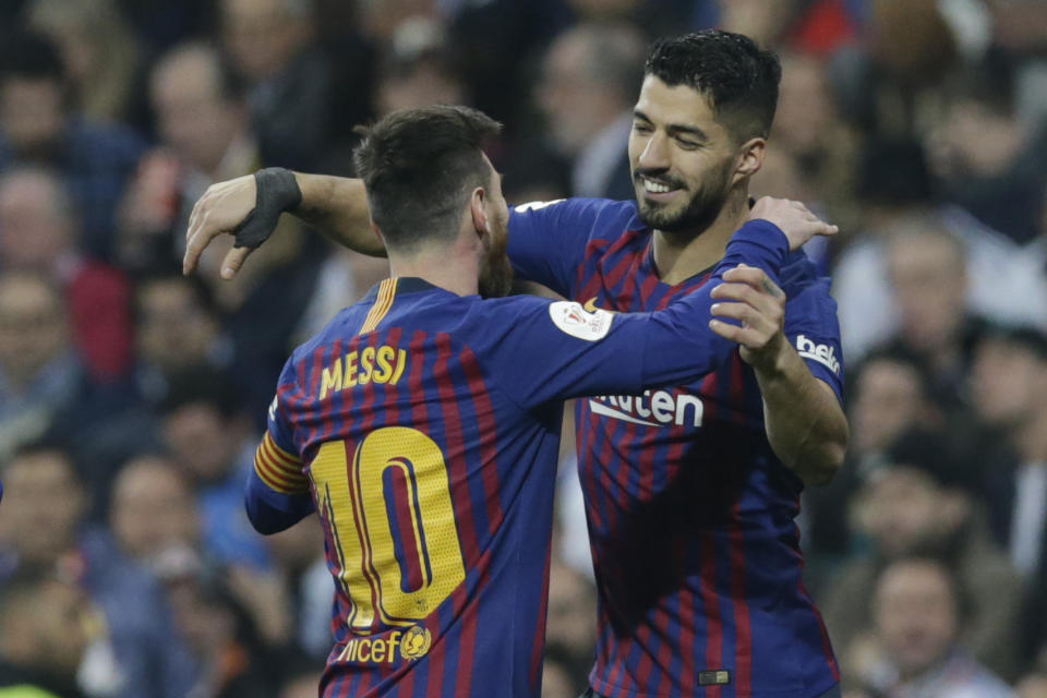 Barcelona forward Luis Suarez, right, celebrates with Barcelona forward Lionel Messi after scoring his side's opening goal during the Copa del Rey semifinal second leg soccer match between Real Madrid and FC Barcelona at the Bernabeu stadium in Madrid, Spain, Wednesday Feb. 27, 2019. (AP Photo/Andrea Comas)