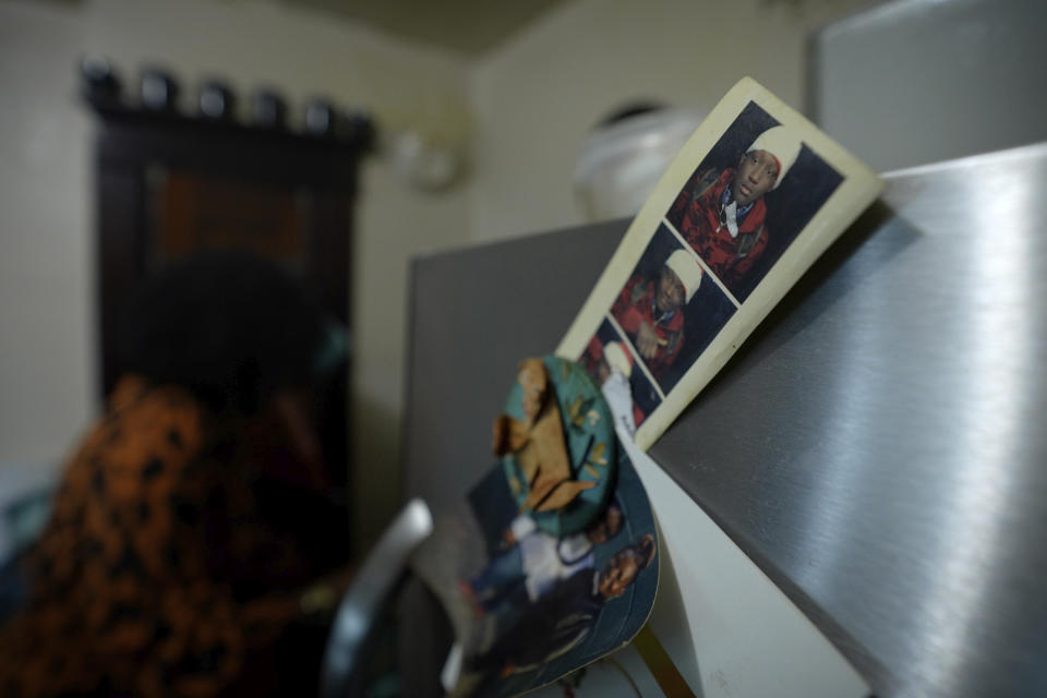 A photo of Zaire Goodman is pinned to the refrigerator door of his mother’s house in Buffalo, N.Y., on Jan. 27, 2023. Goodman was injured in May 2022 when a gunman stormed a Tops supermarket aiming to kill as many Black people as he could. Eight months after the Buffalo supermarket attack, doctors have been unable so far to remove all the bullet fragments lodged inside the body of Goodman, some of them dangerously close to vital organs. But his survival motivates his mother, Zeneta Everhart, to keeping pushing the government for change, and she urges others not to give up fighting when they hear about yet another shooting. (AP Photo/Robert Bumsted)