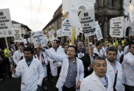 Medical personnel participate in a march against the government of Ecuador's President Rafael Correa in Quito, Ecuador, July 2, 2015. REUTERS/Guillermo Granja