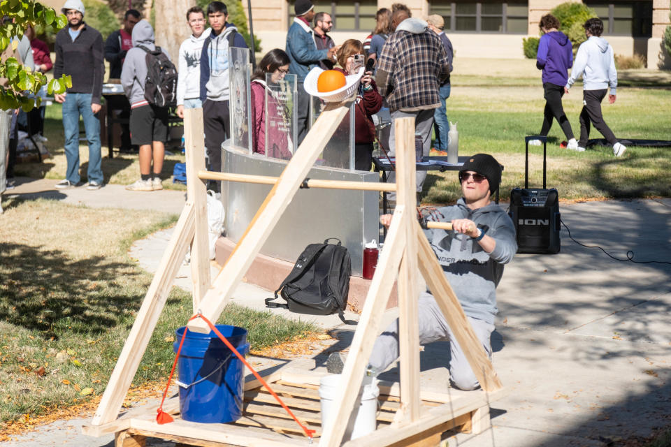 A team member lacunes his pumpkin Thursday at WT's annual "Pumpkin Chunkin" contest on its Canyon campus.