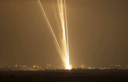 Light streaks and smoke trails are seen as rockets are launched from Gaza towards Israel July 23, 2014. REUTERS/Amir Cohen