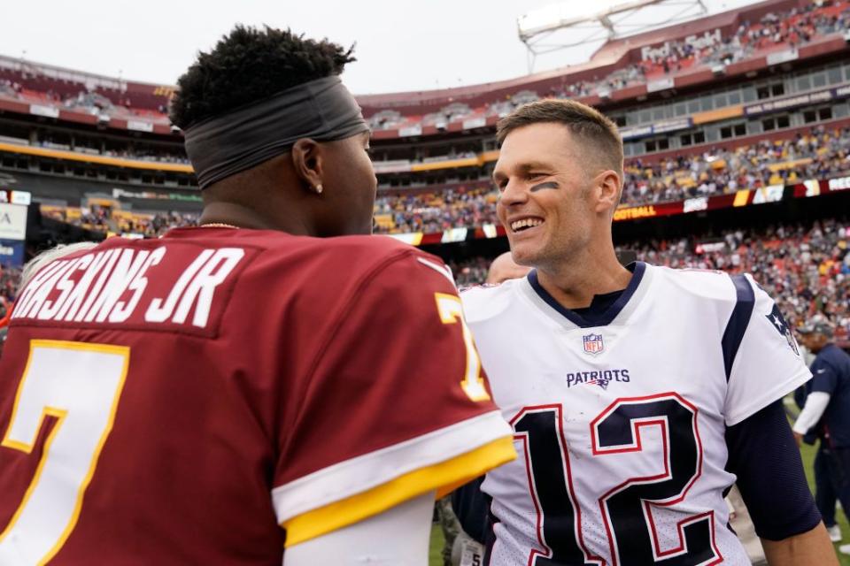 LANDOVER, MD - OCTOBER 06: Tom Brady #12 of the New England Patriots and Dwayne Haskins #7 of the Washington Redskins talk after the Patriots defeated the Redskins 33 to 7 at FedExField on October 6, 2019 in Landover, Maryland. (Photo by Patrick McDermott/Getty Images)