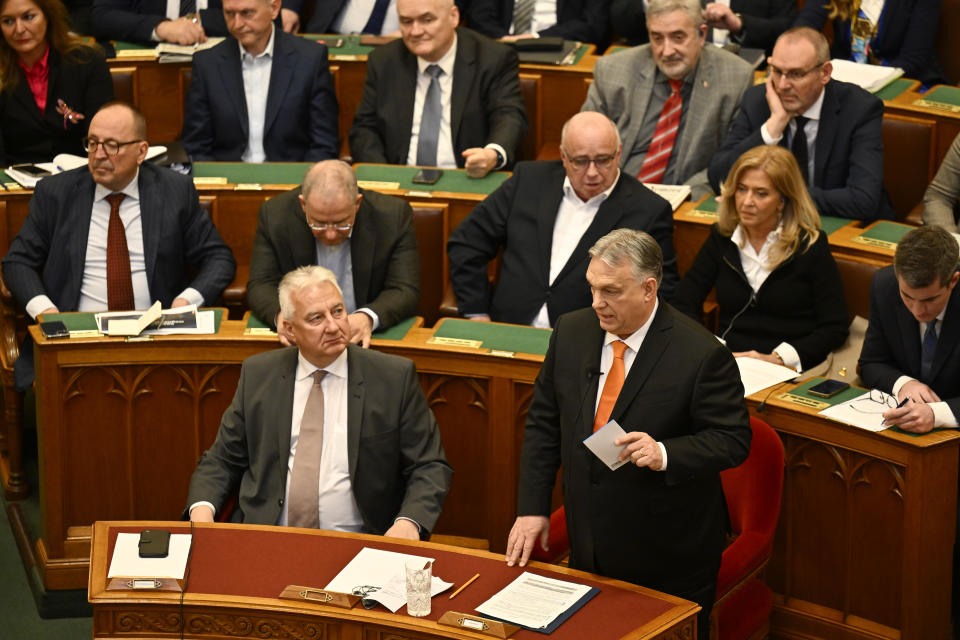 Hungarian Prime Minister Viktor Orban stands after addressing a parliament session, on the day lawmakers are expected to approve Sweden's accession into NATO, in Budapest, Hungary, Monday, Feb 26, 2024. Hungary's parliament is to vote Monday on ratifying Sweden's bid to join NATO, likely bringing an end to more than 18 months of delays that have frustrated the alliance as it seeks to expand in response to Russia's war in Ukraine. (AP Photo/Denes Erdos)