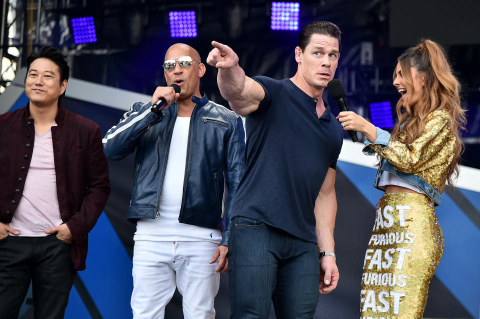 MIAMI, FLORIDA - JANUARY 31: (L-R) Sung Kang, Vin Diesel, John Cena and Maria Menounos speak onstage during Universal Pictures Presents The Road To F9 Concert and Trailer Drop on January 31, 2020 in Miami, Florida. (Photo by Theo Wargo/Getty Images for Universal Pictures)