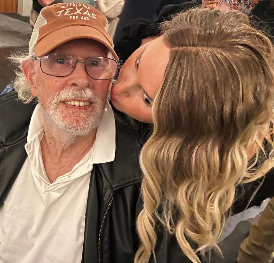 Jenna Dozier, a family friend of "Chocolate Lizards" screenwriter and producer Julie Denny, plants a kiss on actor Bruce Dern at a reception after Wednesday's premiere of the film in Abilene. Dern joined Thomas Haden Church and Carrie-Ann Moss for the showing at the Paramount Theatre.