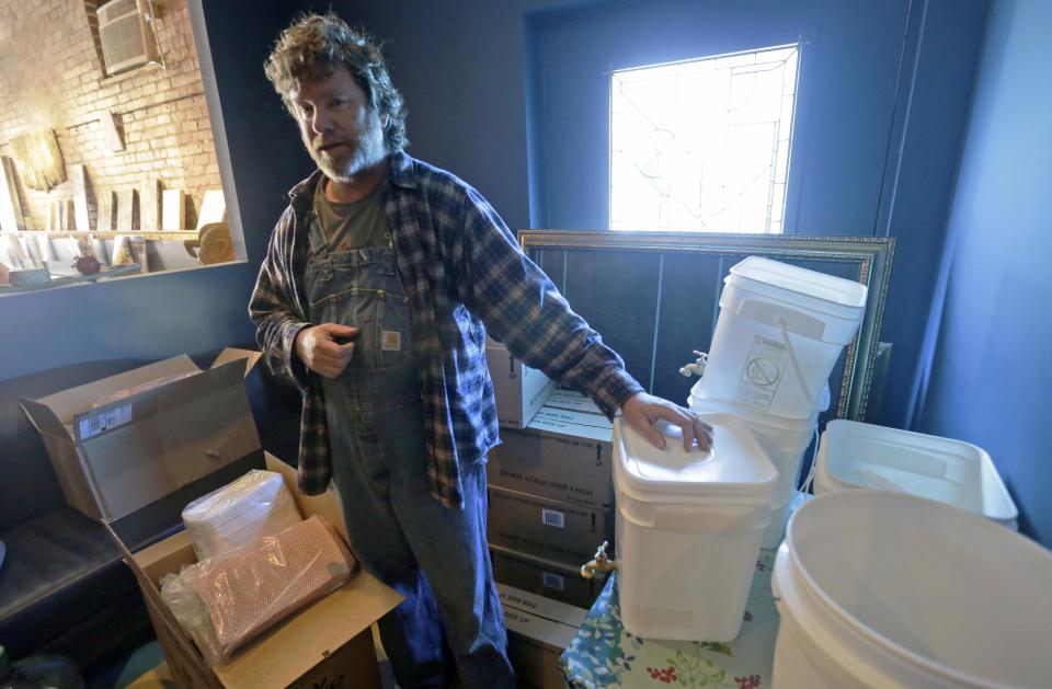 Jonathan Steele, owner of Bluegrass Kitchen, displays hand washing stations that he used in the back of his restaurant in Charleston, W.Va., Tuesday, Jan. 14, 2014. Steele was able to open his restaurant using bottled water on Sunday. He is still using bottled water to cook with. (AP Photo/Steve Helber)