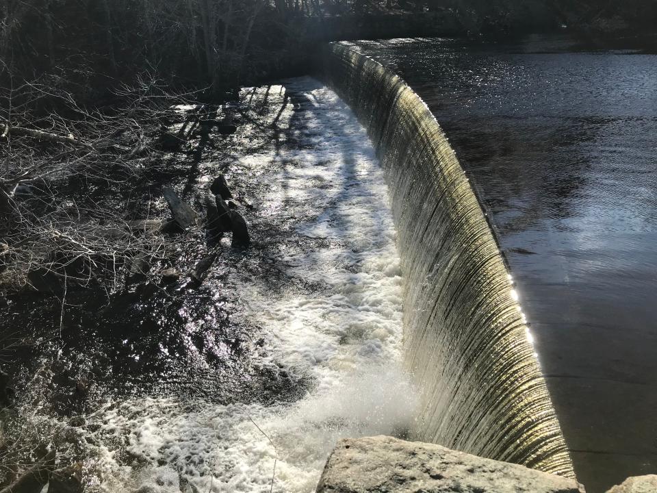 A curved dam and canal built along the Branch River provided water power for the Western Mills, one of several textile factories in Slatersville.