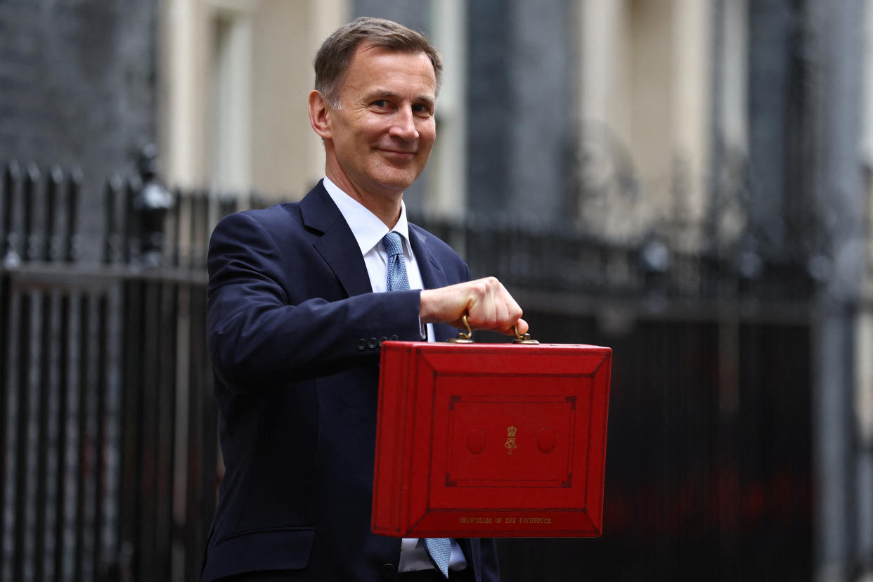 Britain's Chancellor of the Exchequer Jeremy Hunt holds the budget box as he poses for pictures at Downing Street in London, Britain March 15, 2023. REUTERS/Hannah McKay