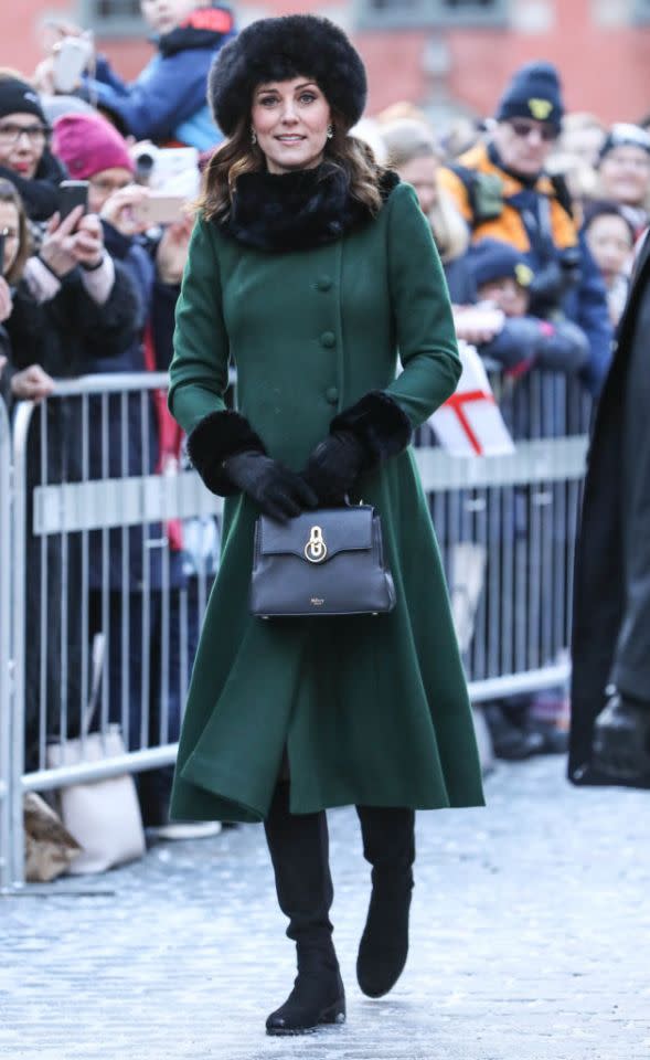 <p>For her first day in snow-laden Stockholm, the Duchess of Cambridge chose an emerald-hued Catherine Walker coat and accessorised the look with a $1,565 <a rel="nofollow noopener" href="https://www.mulberry.com/gb/shop/seaton/mini-seaton-black-small-classic-grain" target="_blank" data-ylk="slk:Mini Seaton Black Bag from Mulberry;elm:context_link;itc:0;sec:content-canvas" class="link ">Mini Seaton Black Bag from Mulberry</a> and faux fur cuffs by <a rel="nofollow noopener" href="https://www.troylondon.com/collections/accessories/products/faux-fur-cuffs-in-black" target="_blank" data-ylk="slk:Troy London;elm:context_link;itc:0;sec:content-canvas" class="link ">Troy London</a> ($70). <em>[Photo: Getty]</em> </p>