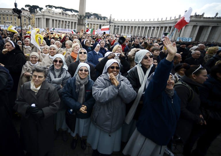 Nuns wave during Pope Benedict XVI's last Angelus prayer on St. Peter's Square at the Vatican on February 24, 2013. Pope Benedict XVI issued a decree on Monday allowing cardinals to bring forward a conclave to elect his successor, as the resignation of a top cardinal and deepening intrigue in the Vatican overshadowed the run-up to the vote