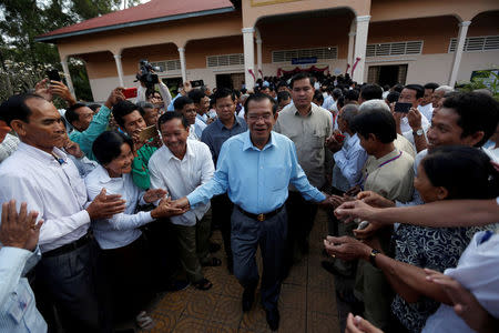 Cambodia's Prime Minister and President of the Cambodian People's Party (CPP), Hun Sen is surrounded by his commune counselors during a Senate election in Takhmao, Kandal province, Cambodia February 25, 2018. REUTERS/Samrang Pring