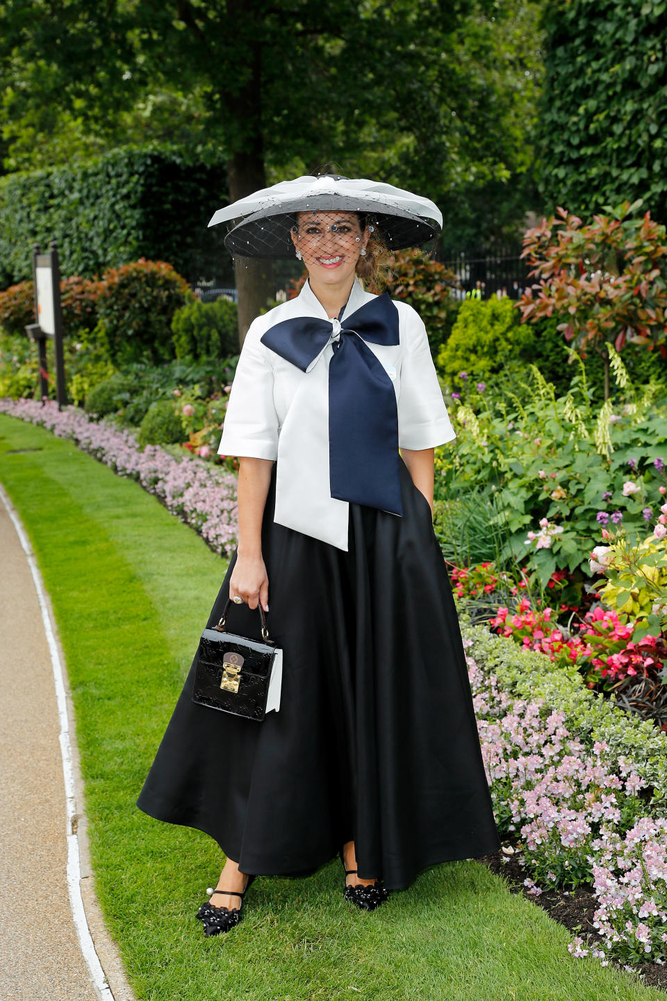 Racegoer Nazer Bullen wearing a full black skirt with a bow-embellished top. <em>[Photo: Getty]</em>