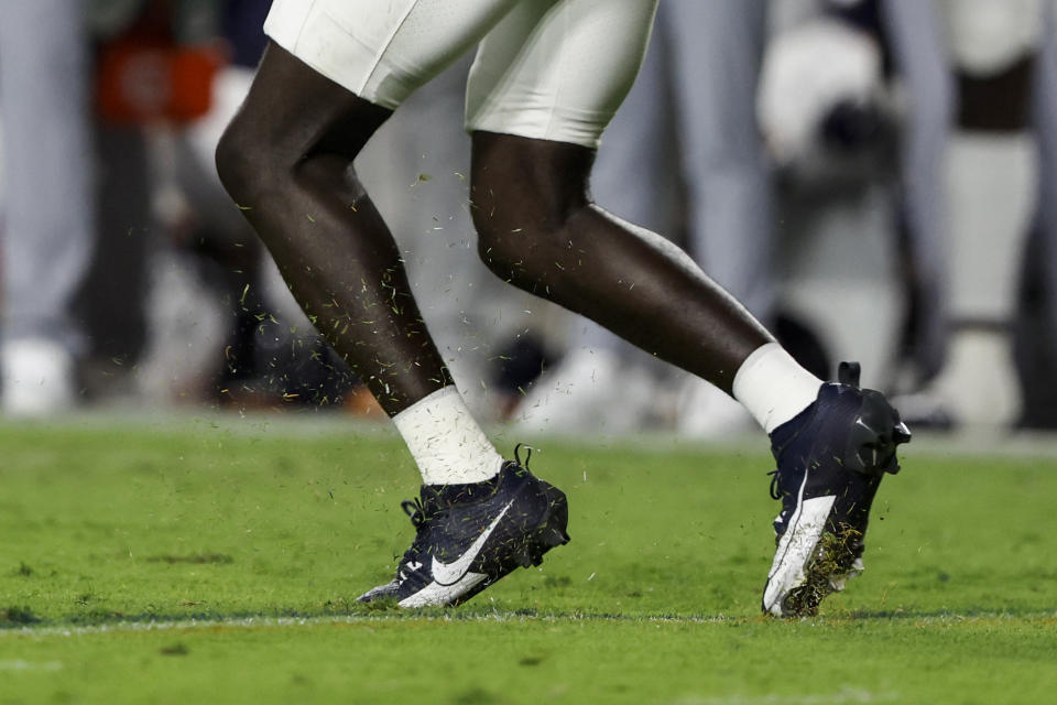 A player runs as he gets traction in the natural turf during the first half of an NCAA college football game between Auburn and Samford on Sept. 16, 2023, in Auburn, Ala. Most of the grass fields in top level of Division I are in the South, Southwest and California. (AP Photo/Butch Dill)