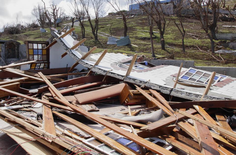 A man inspects a home destroyed by Hurricane Beryl in Clifton, Union Island, St. Vincent and the Grenadines, Thursday, July 4, 2024. (AP Photo/Lucanus Ollivierre)