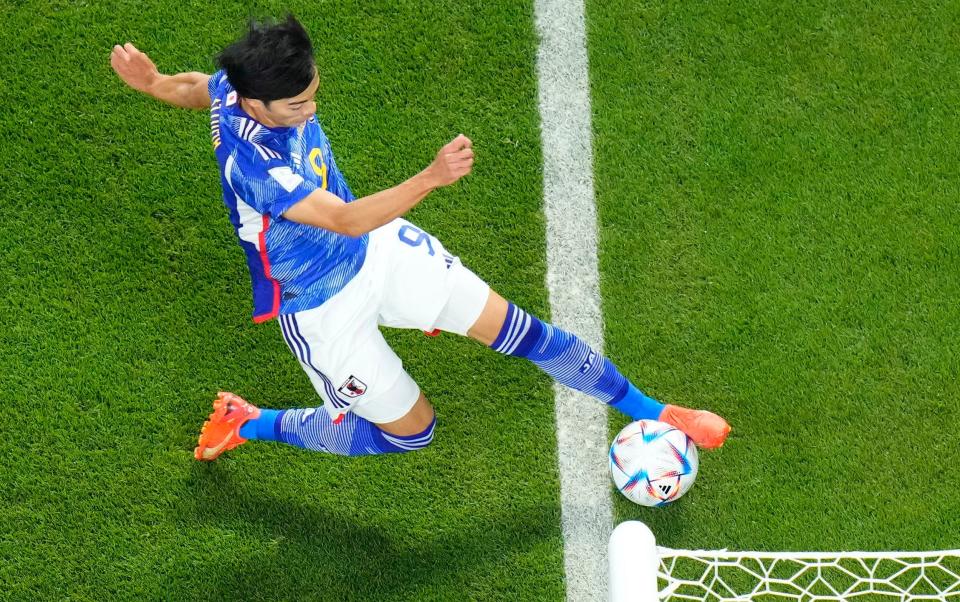 The officials ruled this ball had (just) stayed in play so Japan's second goal was given - AP/David Josek 