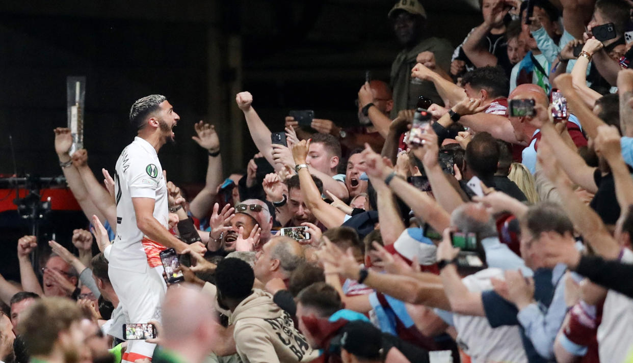 West Ham United's Said Benrahma celebrates scoring their first goal with fans. 