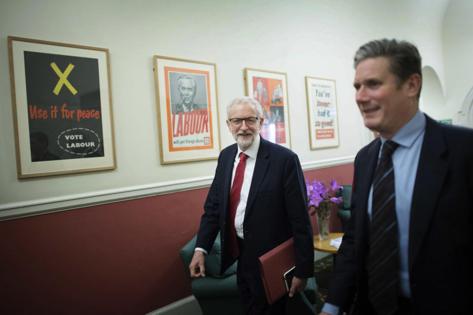 Labour leader Jeremy Corbyn, centre and shadow Brexit secretary Keir Starmer walk to his office at the Houses of Parliament in London, Wednesday April 3, 2019, ahead of a meeting with Britain's Prime Minister Theresa May for talks on ending the impasse over the country's departure from the European Union — a surprise about-face that left pro-Brexit members of May's Conservative Party howling with outrage. (Stefan Rousseau/PA via AP)