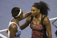 Serena Williams of the U.S. (R) embraces her sister and compatriot Venus Williams after defeating her in their quarterfinals match at the U.S. Open Championships tennis tournament in New York, September 8, 2015. REUTERS/Adrees Latif