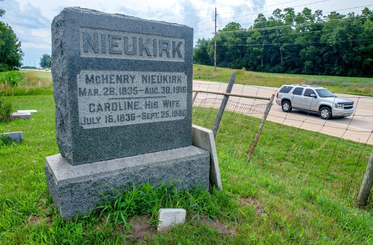 Traffic passes by Haines Cemetery and the large headstone of McHenry Nieukirk and his wife Caroline Heward in Pekin.