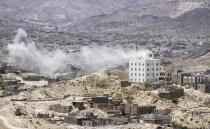 Smoke billows as supporters of exiled Yemeni President Abedrabbo Mansour Hadi clash with Shiite Huthi rebels on the outskirts of the Taez province, on May 3, 2015