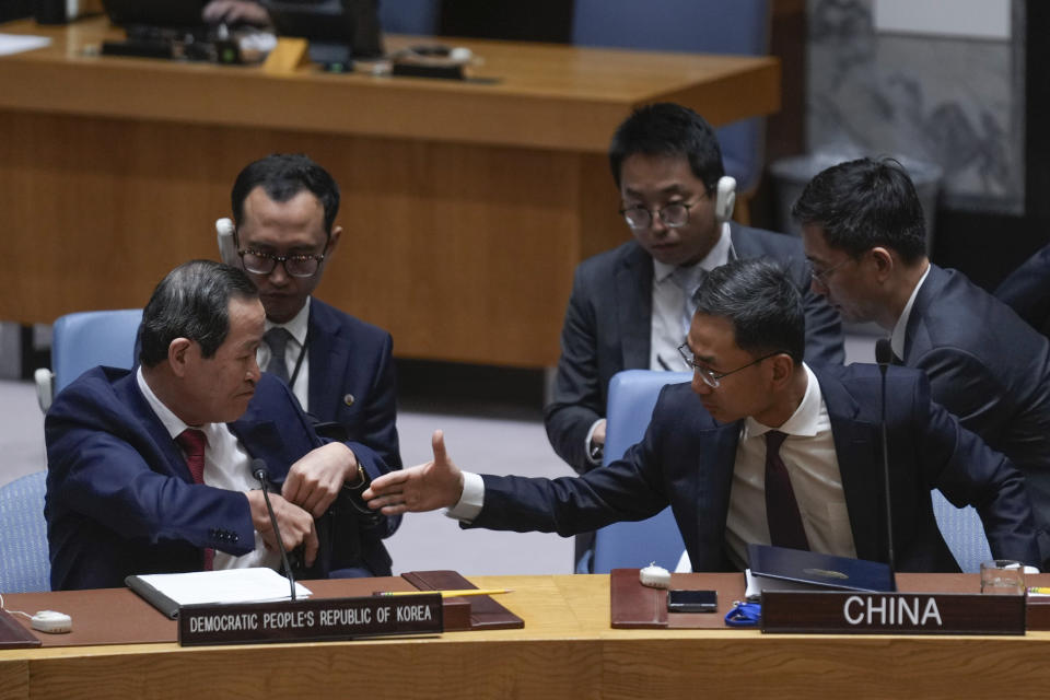 Chinese deputy ambassador to the United Nations Geng Shuang, right, offers his hand to North Korean ambassador to the UN Song Kim at the end of a Security Council meeting at United Nations headquarters, Friday, June 28, 2024. (AP Photo/Seth Wenig)