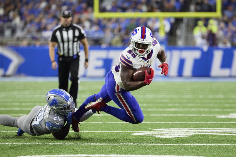 Buffalo Bills running back Devin Singletary is tackled by Detroit Lions cornerback Amani Oruwariye.