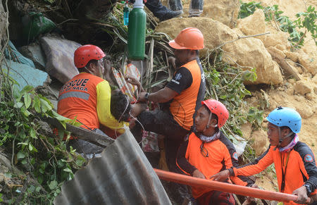 Rescuers pull out a survivor from rubble after a landslide in the City of Naga, Cebu, Philippines September 20, 2018. REUTERS/Stringer