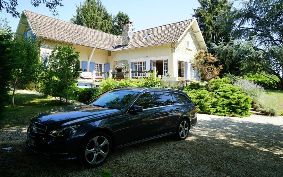 The Mercedes car parked on the driveway outside the Turtle's house