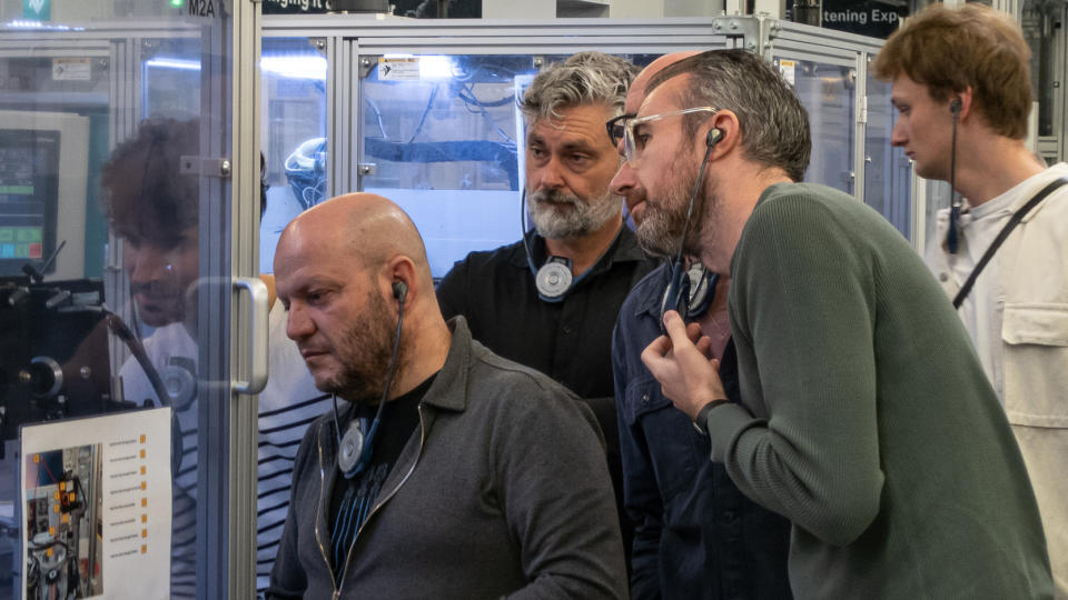 People taking a tour of the Sennheiser factory