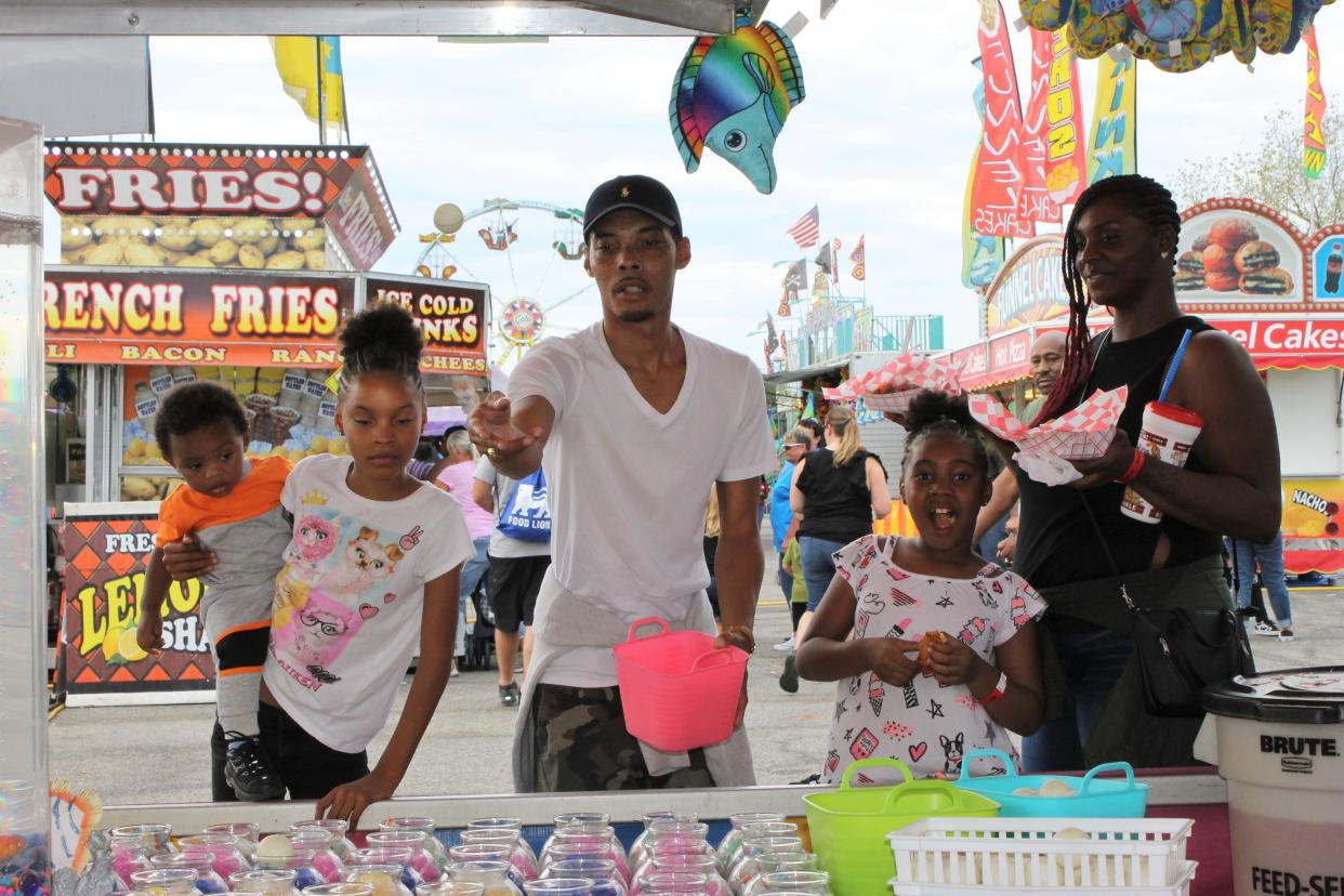 A fairgoer attempts to win a prize at the 2019 Dinwiddie County Fair.