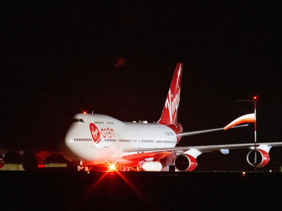 A general view of Cosmic Girl, a repurposed Boeing 747 aircraft carrying the LauncherOne rocket under its left wing, as final preparations are made at Cornwall Airport Newquay on January 9, 2023 in Newquay, United Kingdom.