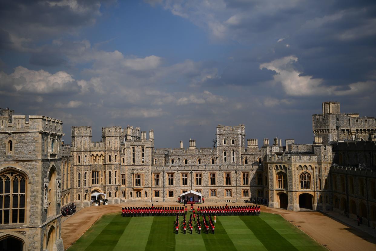 Britain's Queen Elizabeth II (C) and US President Donald Trump (CR) and US First Lady Melania Trump (CL) stand on the dias facing an honour guard formed of soldiers of the Coldstream Guards during a ceremonial welcome in the Quadrangle of Windsor Castle in Windsor, west of London, on July 13, 2018 on the second day of Trump's UK visit. - US President Donald Trump launched an extraordinary attack on Prime Minister Theresa May's Brexit strategy, plunging the transatlantic "special relationship" to a new low as they prepared to meet Friday on the second day of his tumultuous trip to Britain. (Photo by Ben STANSALL / various sources / AFP)        (Photo credit should read BEN STANSALL/AFP via Getty Images)