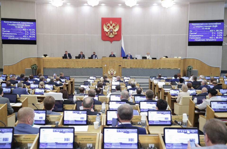 In this photo provided by the State Duma, deputies attend a session at the State Duma, the Lower House of the Russian Parliament in Moscow, Russia, Wednesday, May 19, 2021. The Russian parliament's lower house has voted to withdraw from an international treaty allowing surveillance flights over military facilities following the U.S. departure from the pact. The Russian exit from the Open Skies Treaty is yet to be endorsed by the upper house of parliament and needs to be signed by President Vladimir Putin to take effect. (The State Duma, The Federal Assembly of The Russian Federation via AP)