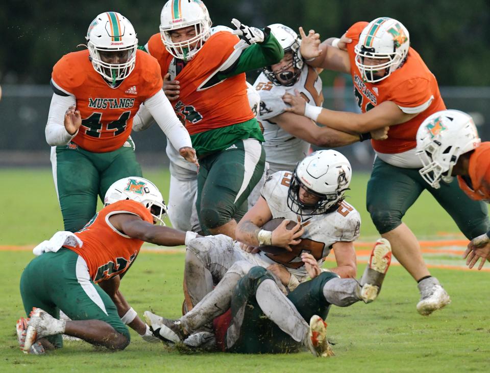 Atlantic Coast Stingrays Jayce Wellman (20) is brought down on a second quarter run by the Mandarin Mustangs defense. The Atlantic Coast Stingrays traveled to Mandarin to play the Mustangs in High School football Friday, September 15, 2023.