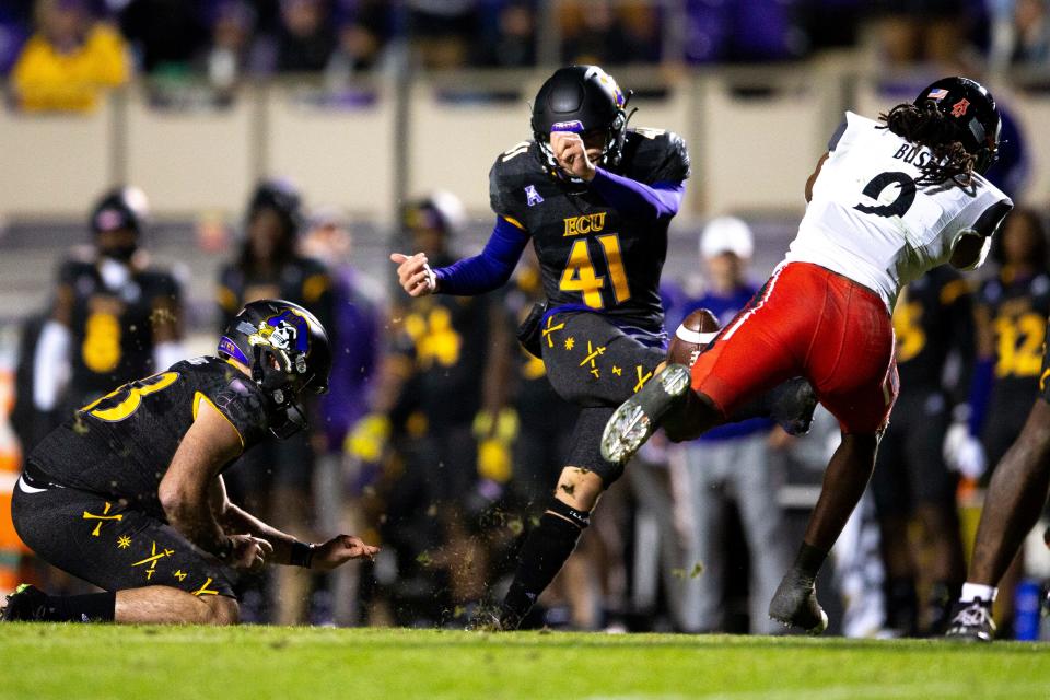 Cincinnati Bearcats cornerback Arquon Bush (9) blocks a field goal attempt by East Carolina Pirates place kicker Owen Daffer (41) in the second half of the NCAA football game at Dowdy-Ficklen Stadium in Greenville, NC, on Friday, Nov. 26, 2021. Cincinnati Bearcats defeated East Carolina Pirates 35-13. 