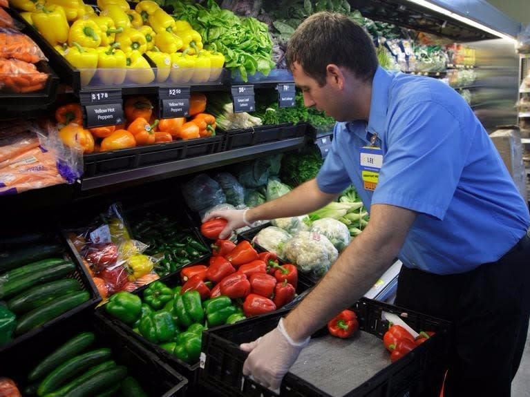 A worker stocks a new Walmart Express store in Chicago July 26, 2011. 
REUTERS/John Gress  