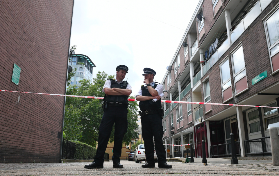 Police guard the cordon in Munster Square following the killing (PA)