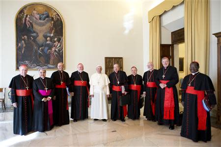 Pope Francis poses with cardinals during a meeting at the Vatican October 1, 2013. REUTERS/Osservatore Romano