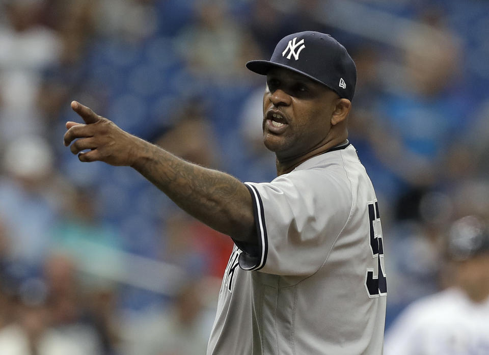 FILE - In this Sept. 27, 2018, file photo, New York Yankees' CC Sabathia points at the Tampa Bay Rays dugout after he was ejected for hitting Tampa Bay Rays' Jesus Sucre with a pitch during the sixth inning of a baseball game, in St. Petersburg, Fla. The New York Yankees gave pitcher CC Sabathia a $500,000 performance bonus, even though the 38-year-old left-hander was ejected from his final regular-season start six outs shy of the 155 innings specified for the payment in his contract. (AP Photo/Chris O'Meara, File)