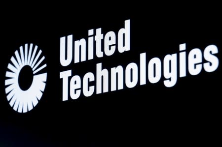 FILE PHOTO: The ticker symbol for for United Technologies is displayed at the post where it is traded on the floor of the NYSE