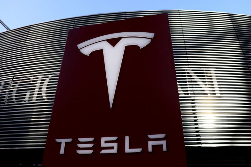 FILE PHOTO: FILE PHOTO: Logo of the electric vehicle maker Tesla is seen near a shopping complex in Beijing