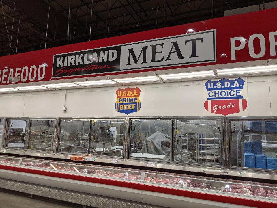 Costco meat section with cuts on display and "Kirkland meat" sign