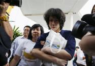 Teen blogger Amos Yee leaves with his parents after his sentencing, from the State Courts in Singapore July 6, 2015. REUTERS/Edgar Su