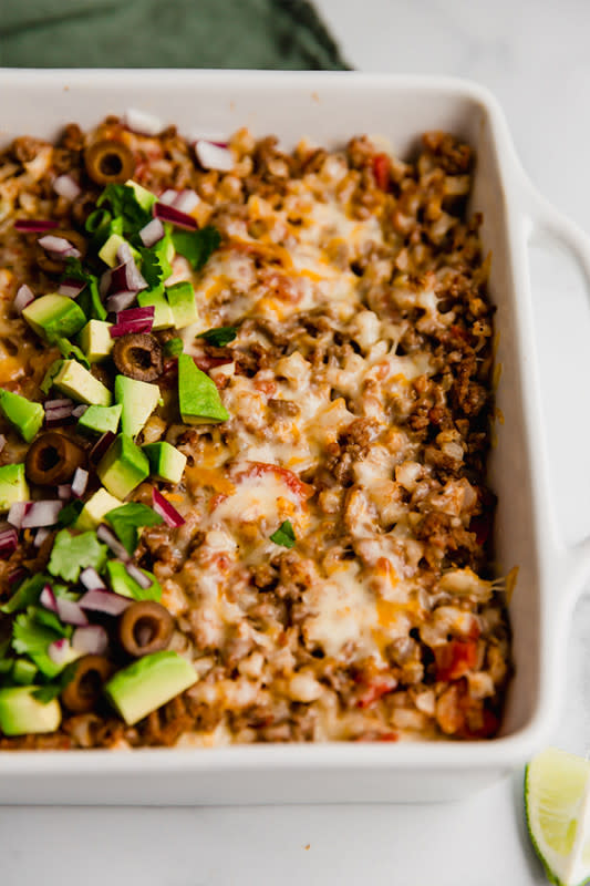 <p>This taco cauliflower rice casserole is made with ground beef and cauliflower rice-filled layered in between grain-free tortillas! It’s gluten-free, and can easily be made dairy-free and paleo.</p><p><strong>Get the recipe: <a href="https://unboundwellness.com/taco-cauliflower-rice-casserole/" rel="nofollow noopener" target="_blank" data-ylk="slk:Taco Cauliflower Rice Casserole;elm:context_link;itc:0;sec:content-canvas" class="link rapid-noclick-resp">Taco Cauliflower Rice Casserole</a></strong></p>